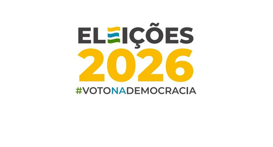 Logomarca oficial das Eleições 2026 nas cores preta, amarelo, azul e verde, com a hashtag Voto n...