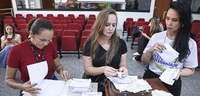 A foto mostra servidoras da Justiça Eleitoral preparando as urnas que serão utilizadas na audito...